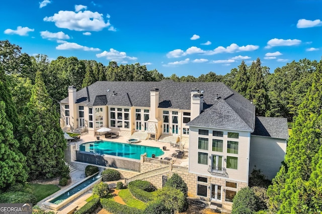 9620 Cedar Grove Rd, Fairburn, GA 30213 - rear view of property with french doors, a chimney, a patio area, and an outdoor pool