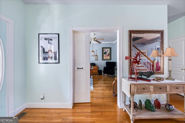 hall featuring crown molding and light wood-type flooring