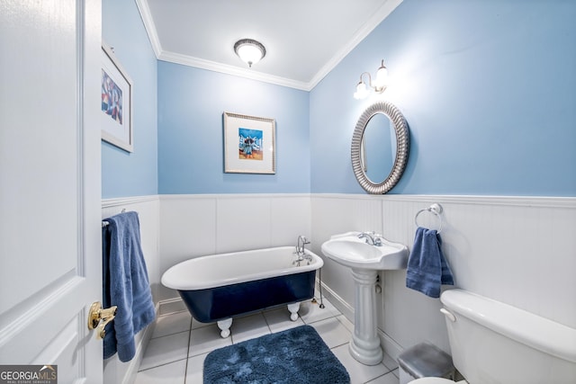 bathroom featuring a tub to relax in, crown molding, toilet, and tile patterned flooring