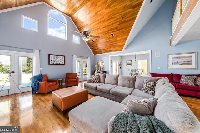 living room with french doors, light hardwood / wood-style flooring, wooden ceiling, and high vaulted ceiling