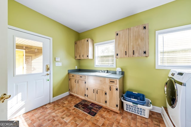 laundry room with sink, washer / clothes dryer, and cabinets