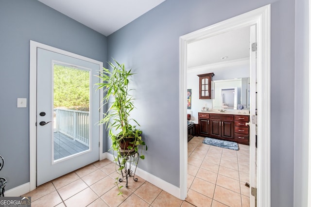 doorway to outside featuring sink and light tile patterned floors