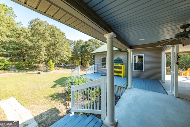 deck featuring ceiling fan and a yard