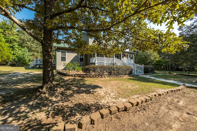 obstructed view of property with covered porch and a front yard