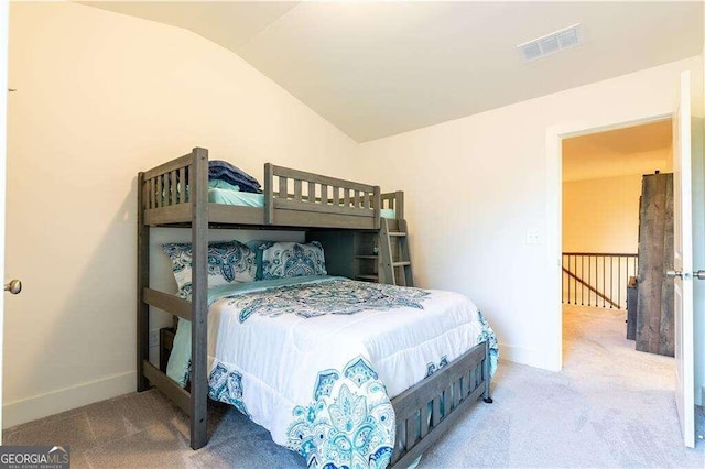 bedroom featuring carpet and vaulted ceiling