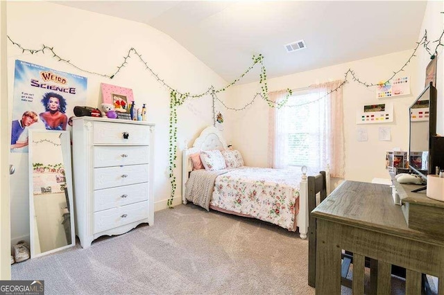 bedroom with carpet floors and lofted ceiling