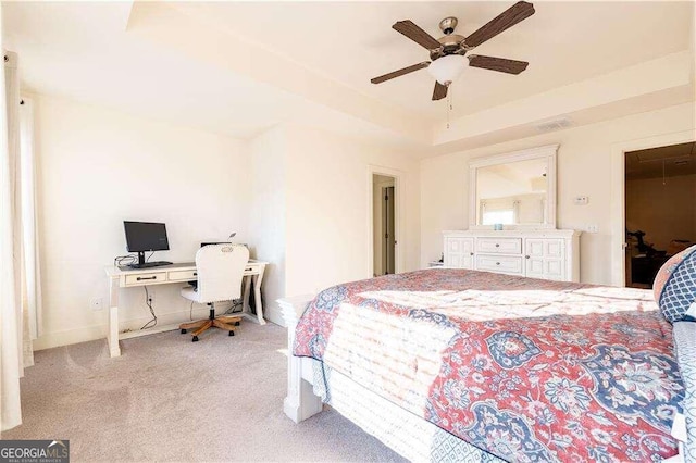 bedroom with a spacious closet, a closet, ceiling fan, and light colored carpet