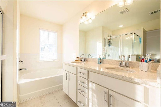 bathroom featuring tile patterned flooring, independent shower and bath, and vanity