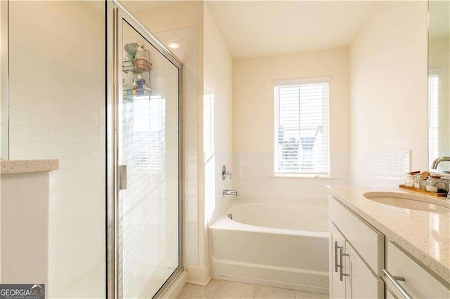 bathroom with vanity, shower with separate bathtub, and tile patterned flooring