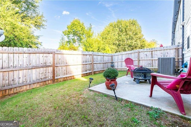 view of yard featuring central AC unit, a patio, and an outdoor fire pit