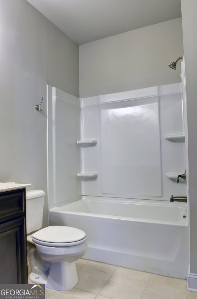 full bathroom with shower / bathing tub combination, tile patterned floors, vanity, and toilet