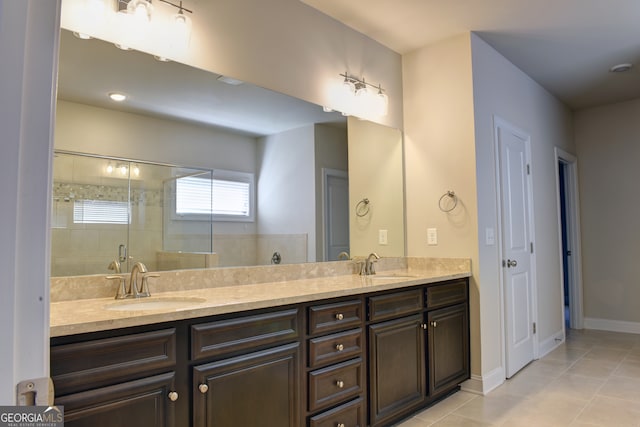 bathroom featuring tile patterned flooring, vanity, and a shower with shower door