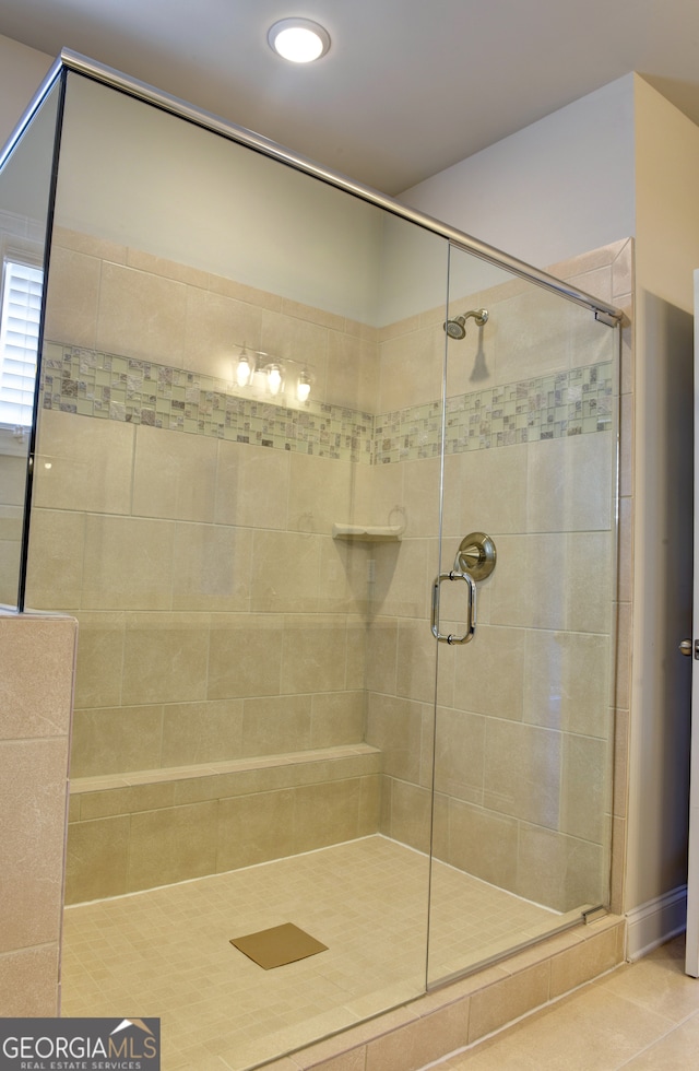 bathroom featuring walk in shower and tile patterned floors