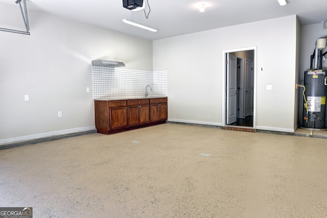 garage featuring gas water heater, a garage door opener, and sink