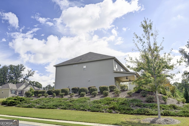 view of side of property with a lawn