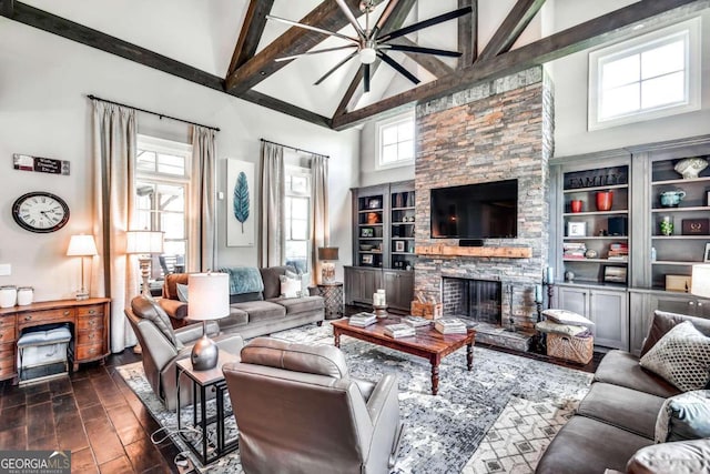 living room with a fireplace, beam ceiling, ceiling fan, and high vaulted ceiling