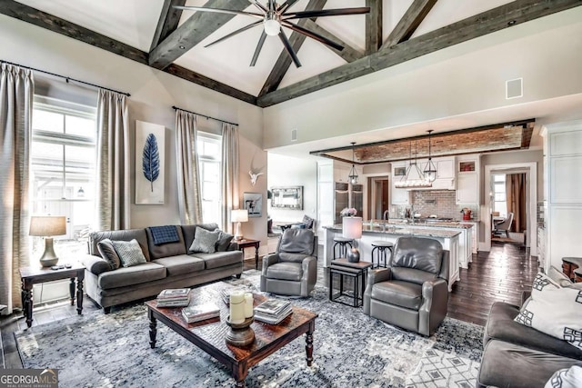 living room featuring ceiling fan, beamed ceiling, dark wood-type flooring, and high vaulted ceiling