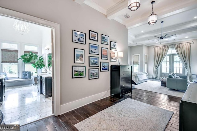 interior space with beam ceiling, a chandelier, and dark hardwood / wood-style floors