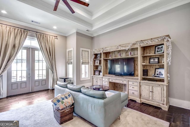 living room with ornamental molding, dark wood-type flooring, and ceiling fan