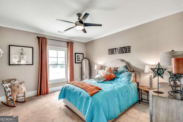 bedroom featuring ceiling fan, light carpet, and ornamental molding