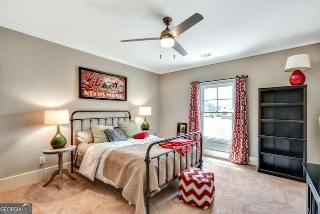 bedroom with ceiling fan, carpet floors, and crown molding