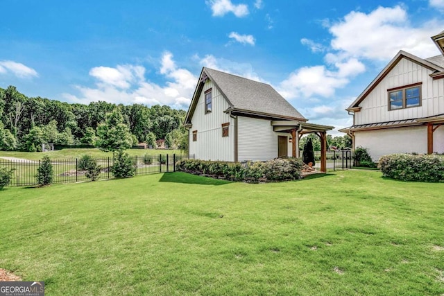 view of side of property with a yard