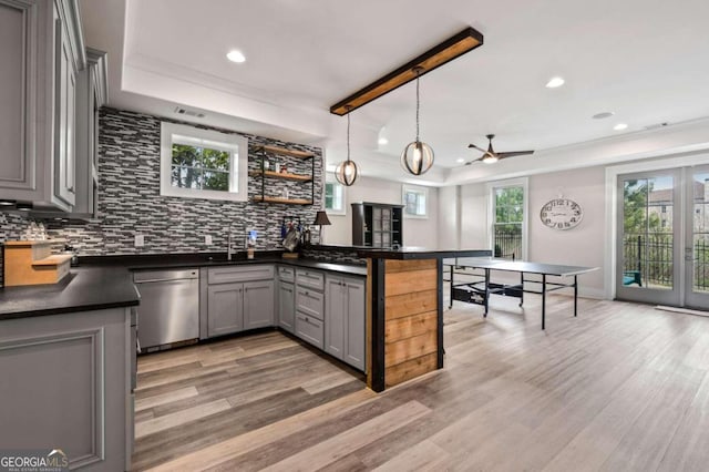 kitchen with ceiling fan, kitchen peninsula, dishwasher, gray cabinets, and light wood-type flooring