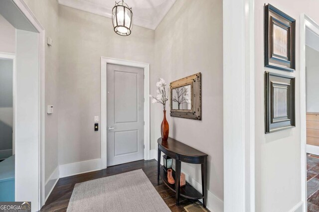 entrance foyer with a notable chandelier and dark wood-type flooring