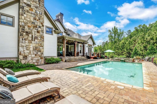 view of swimming pool with a patio area