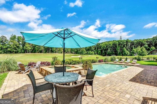 view of swimming pool with a yard and a patio