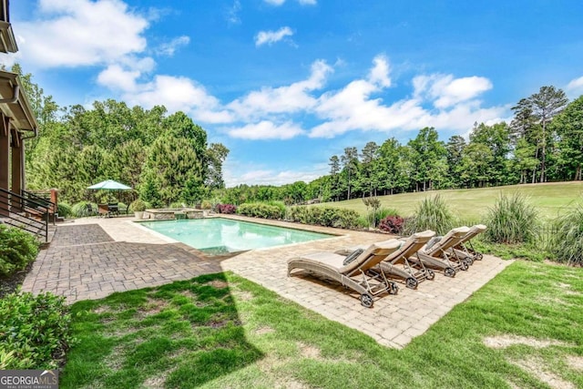 view of swimming pool featuring a yard and a patio