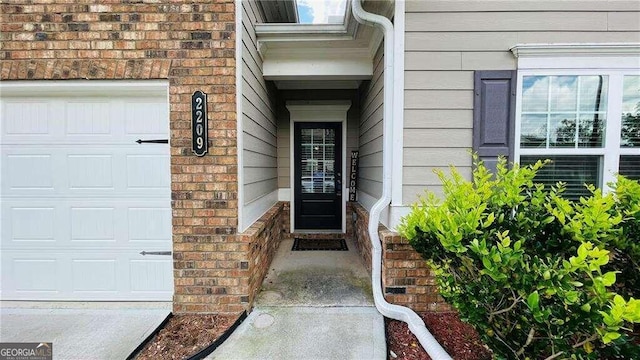 view of exterior entry featuring a garage