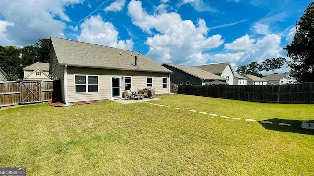 rear view of house with a lawn and a patio area