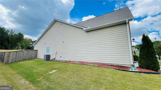 view of property exterior with a lawn and cooling unit