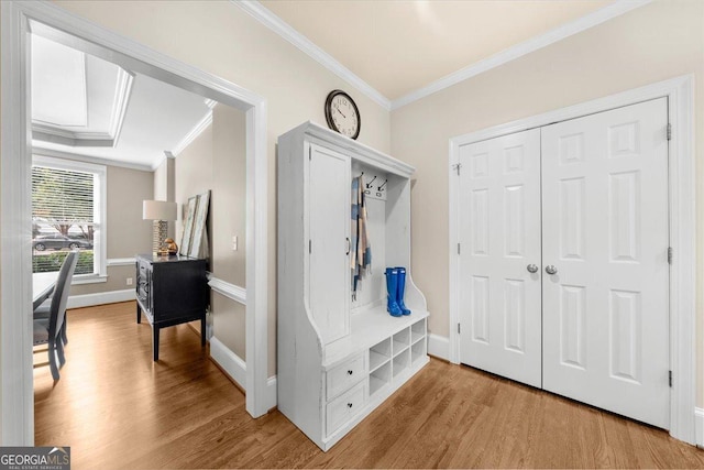 mudroom with light hardwood / wood-style floors and ornamental molding