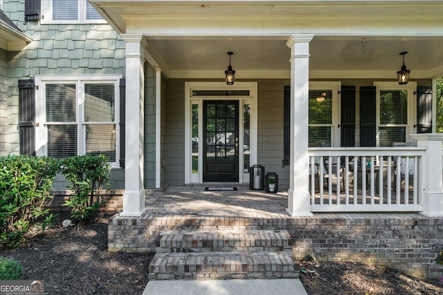 view of exterior entry with covered porch