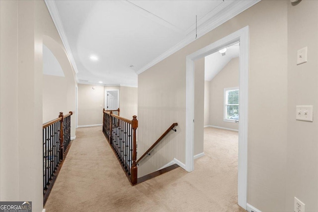 corridor featuring crown molding, light colored carpet, and lofted ceiling