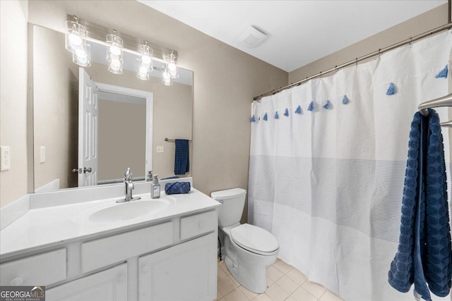 bathroom featuring tile patterned flooring, vanity, and toilet