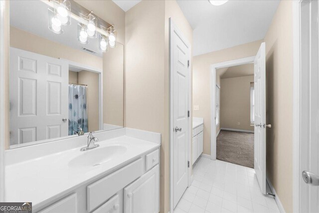 bathroom with tile patterned flooring and vanity