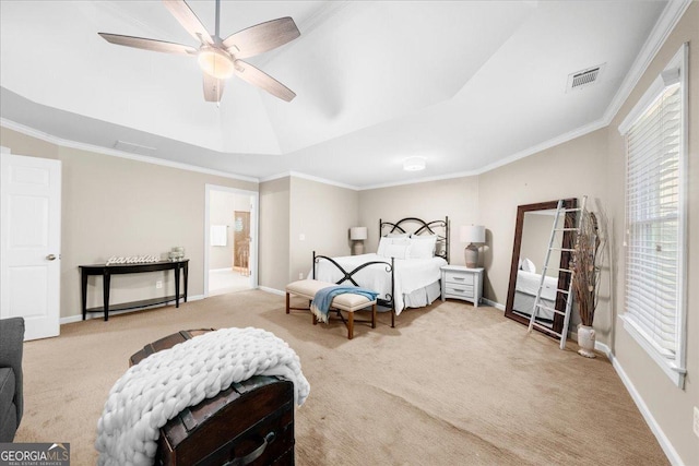 carpeted bedroom with a tray ceiling, multiple windows, ceiling fan, and crown molding