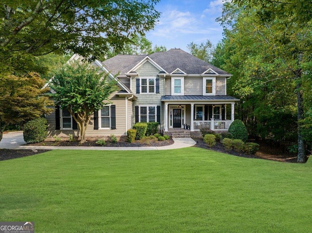 craftsman inspired home with covered porch and a front lawn