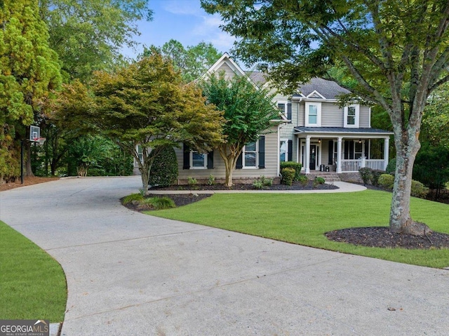 view of front facade featuring covered porch and a front yard