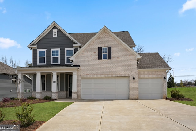 view of front of house with a garage, a front lawn, and covered porch