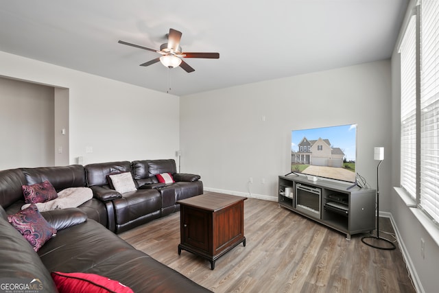 living room featuring light hardwood / wood-style floors and ceiling fan