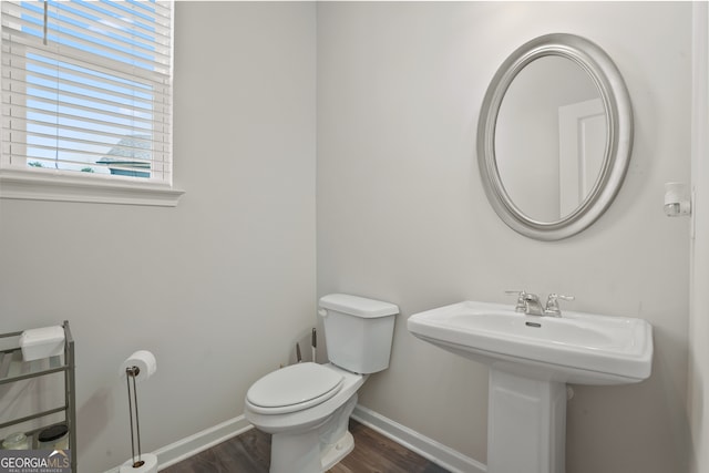 bathroom featuring hardwood / wood-style floors and toilet