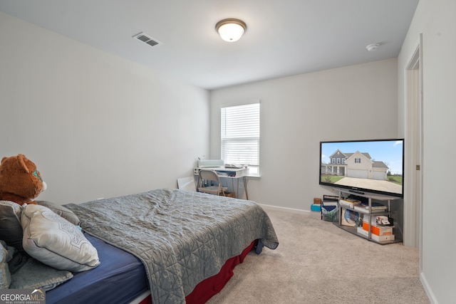 bedroom featuring light carpet