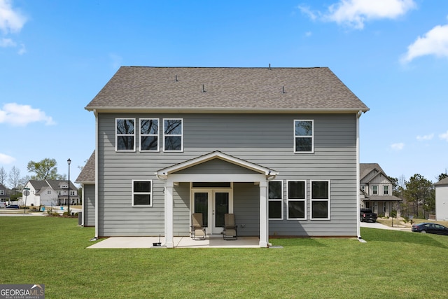 rear view of property with a patio and a yard