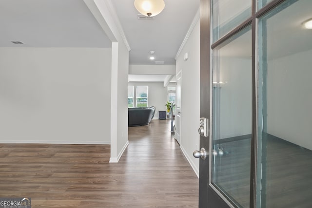 hallway featuring crown molding and dark wood-type flooring