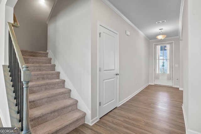 interior space with hardwood / wood-style flooring and ornamental molding