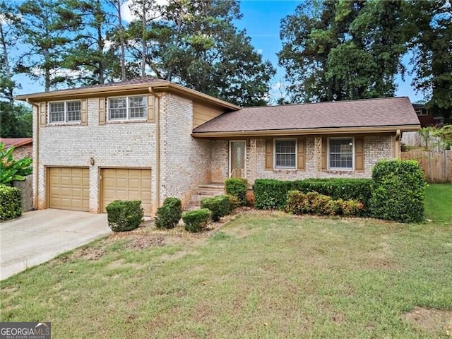 tri-level home with a garage and a front lawn